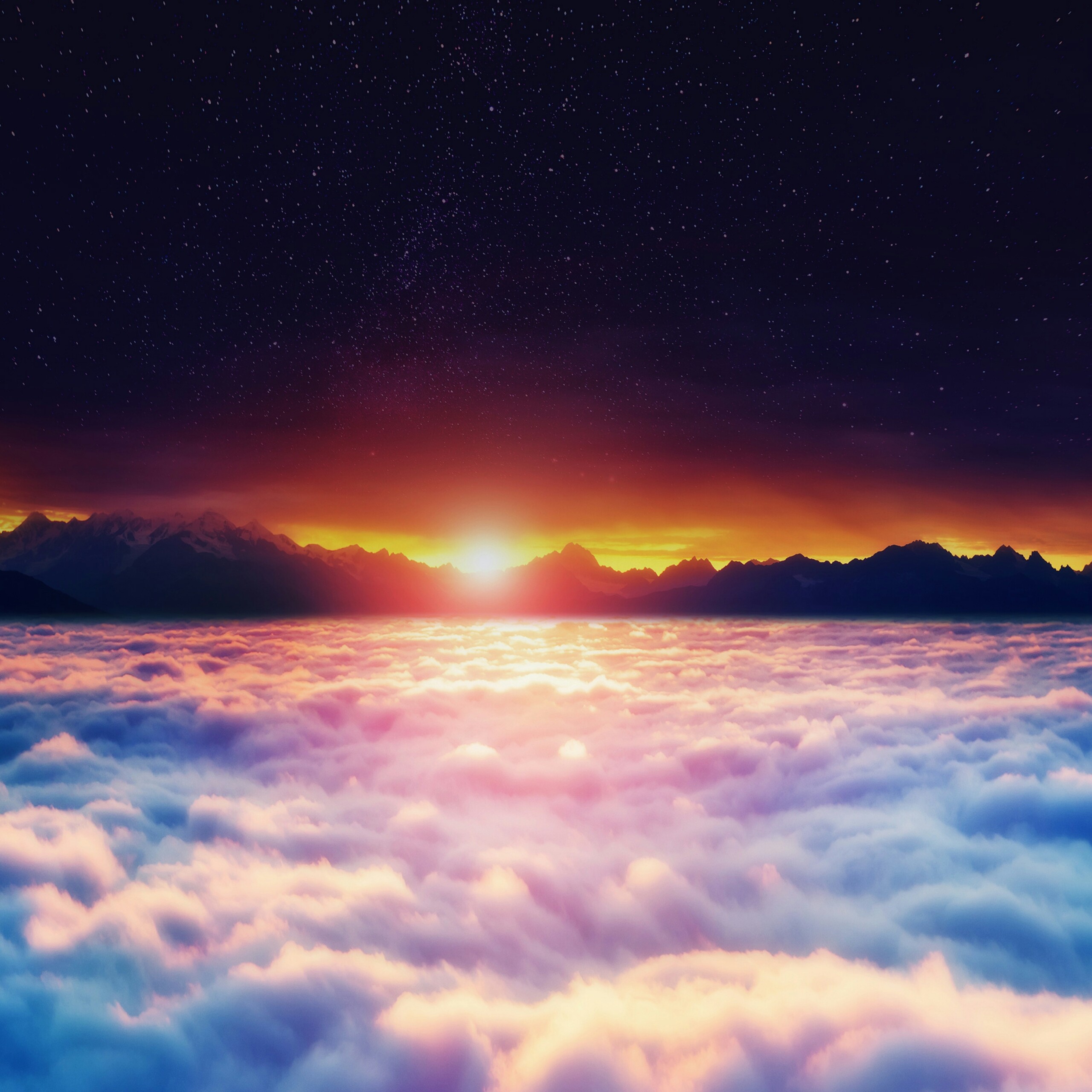 Sunrise over a sea of clouds with a mountain range in the background, suitable for a laptop wallpaper