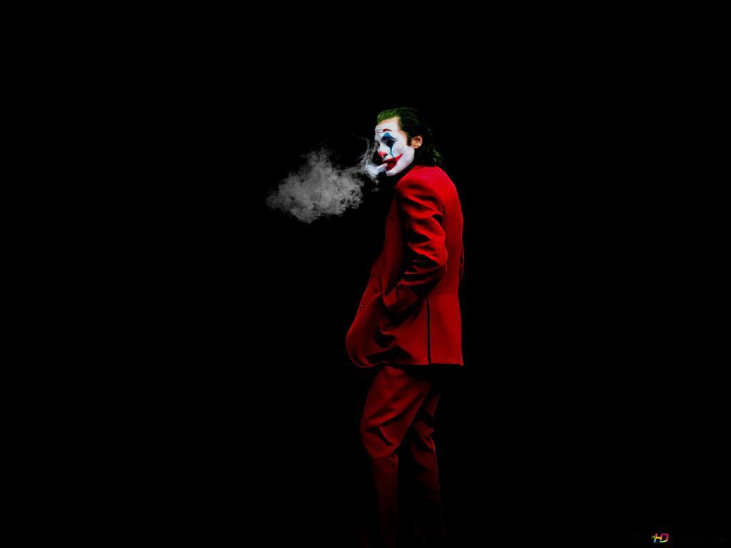 Movie Star Joker In Red Jacket Smoking Front Of Black