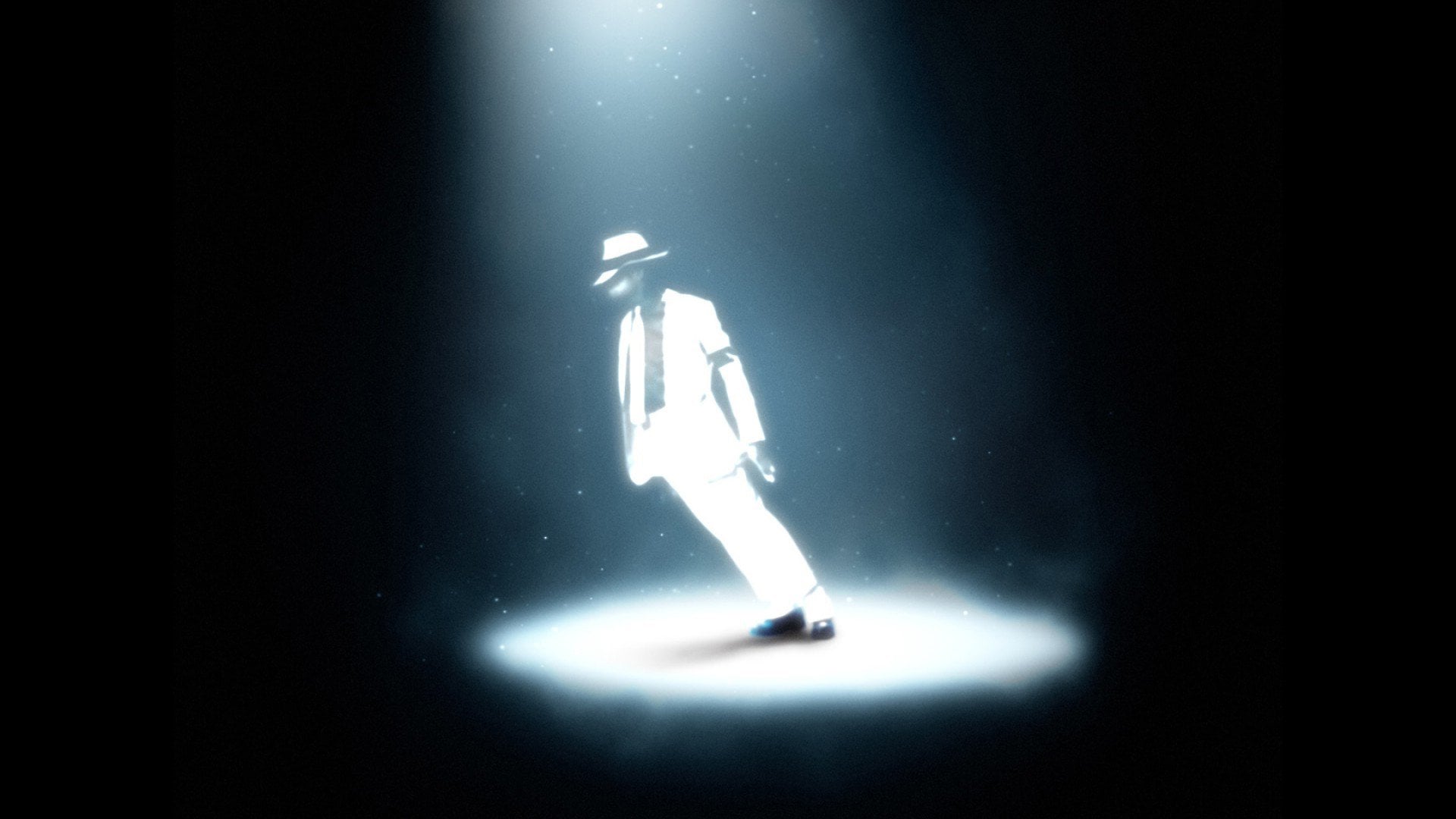 A performer in a white suit and hat illuminated by a spotlight on a dark stage