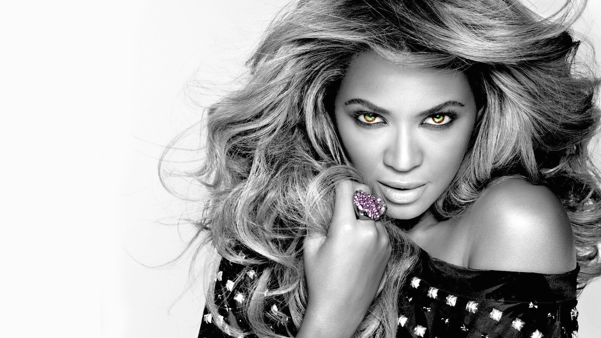 Black and white portrait of Beyoncé with highlighted eyes and a glamorous pose