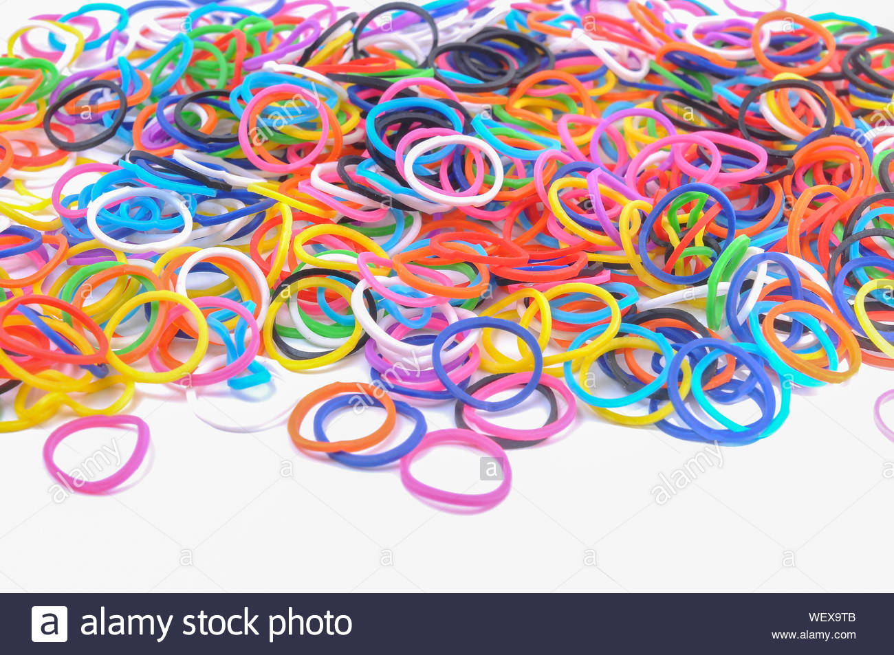 Close Up Of Colorful Rubber Bands On White Background Stock Photo