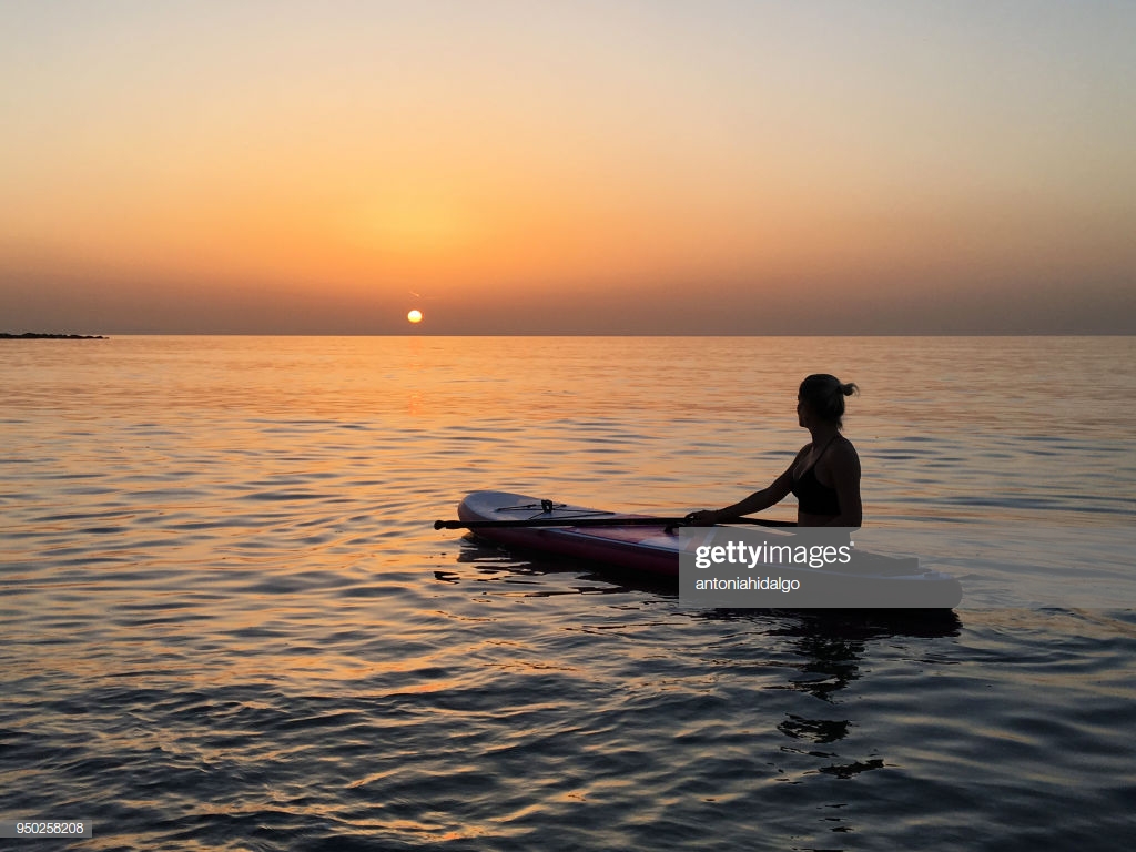 Girl Practicing Yoga On Sup In The Mediterranean Sea Stock Photo