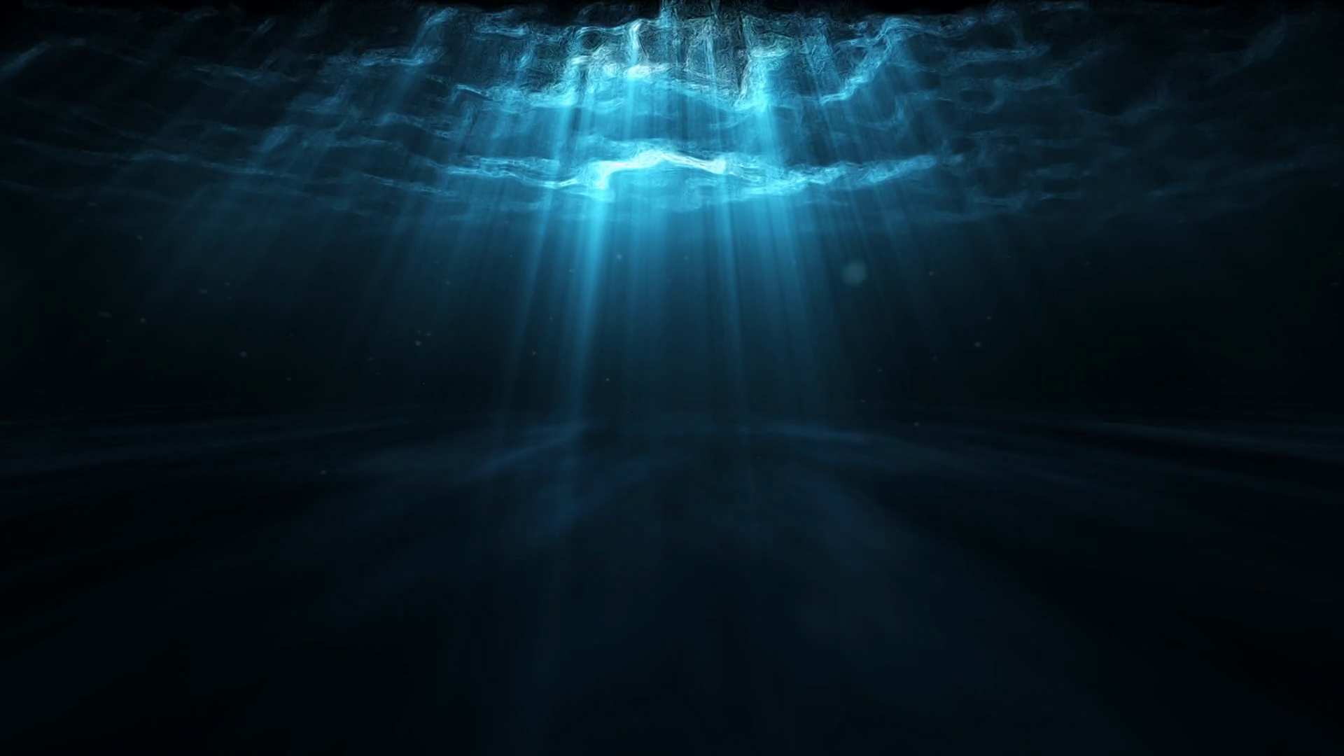 Dark underwater scene with beams of light filtering through the surface