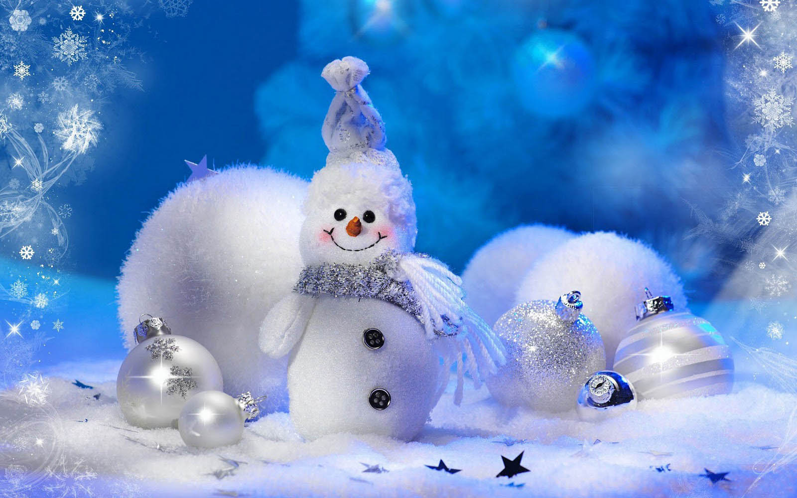 A cheerful snowman figurine sits amidst snowy white pom-poms and sparkling silver and white Christmas ornaments, set against a blurred blue backdrop of snowflakes and festive lights, evoking a warm and whimsical winter wonderland