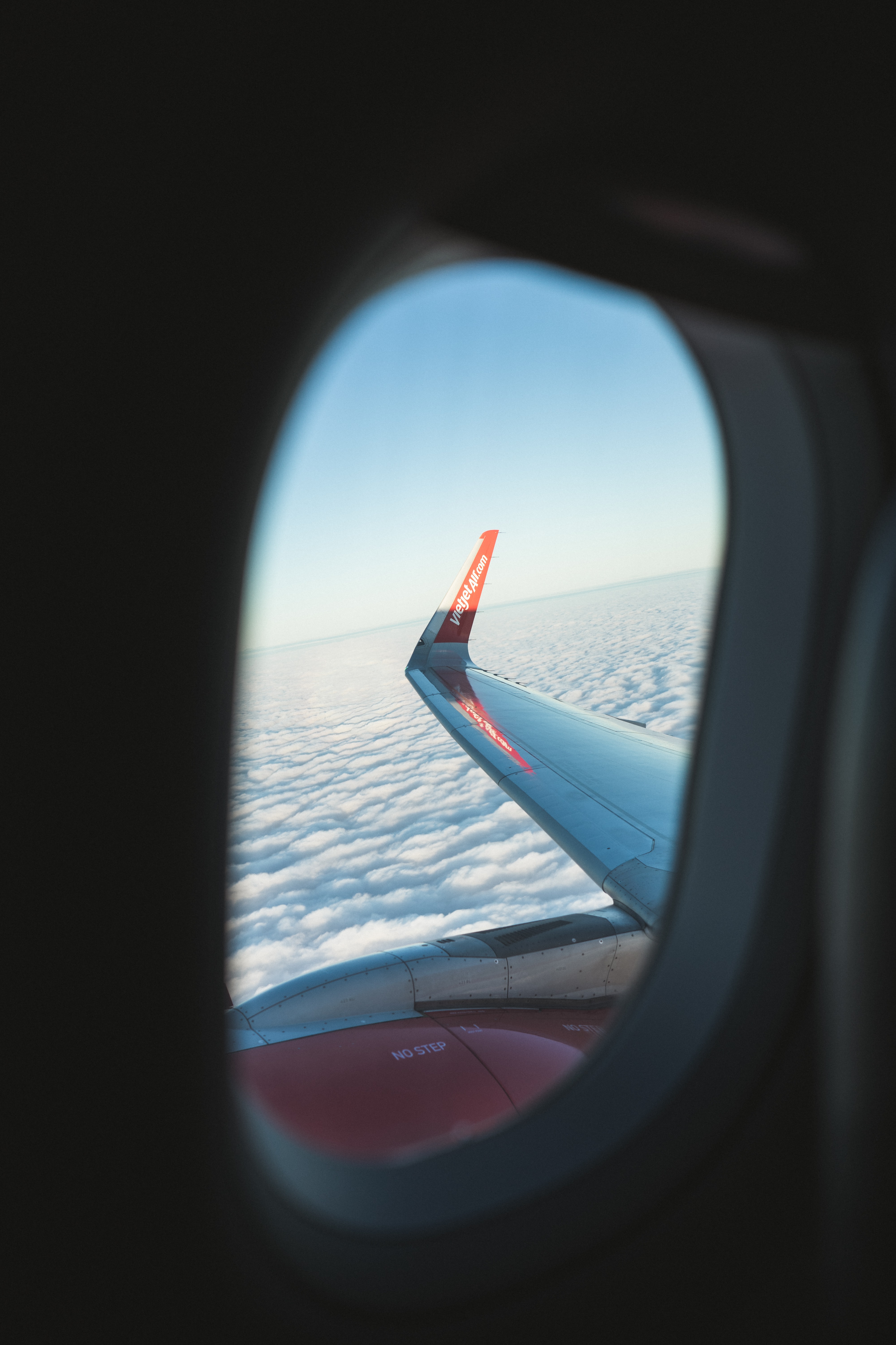 Wallpaper Porthole Window Plane Wing Clouds