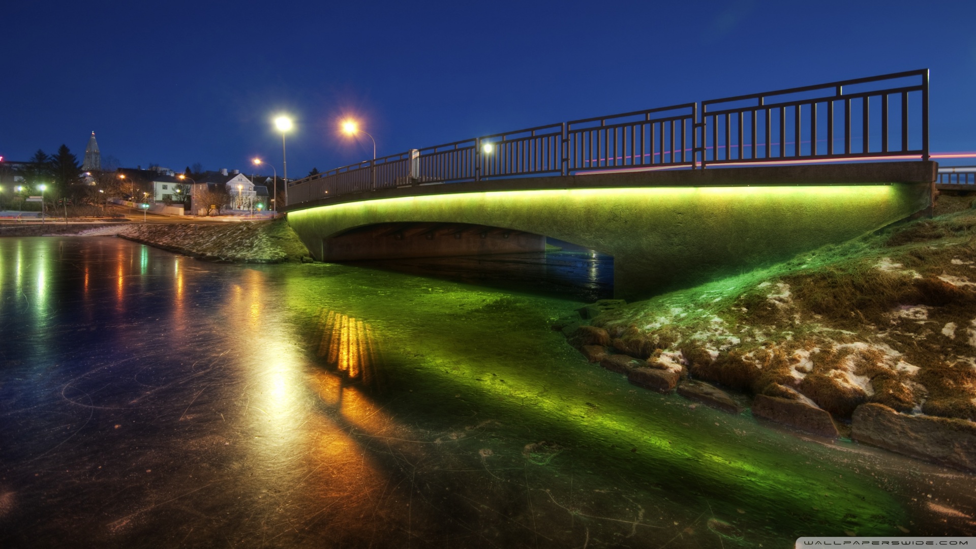 Bridge Over A Frozen Pond At Night Wallpaper