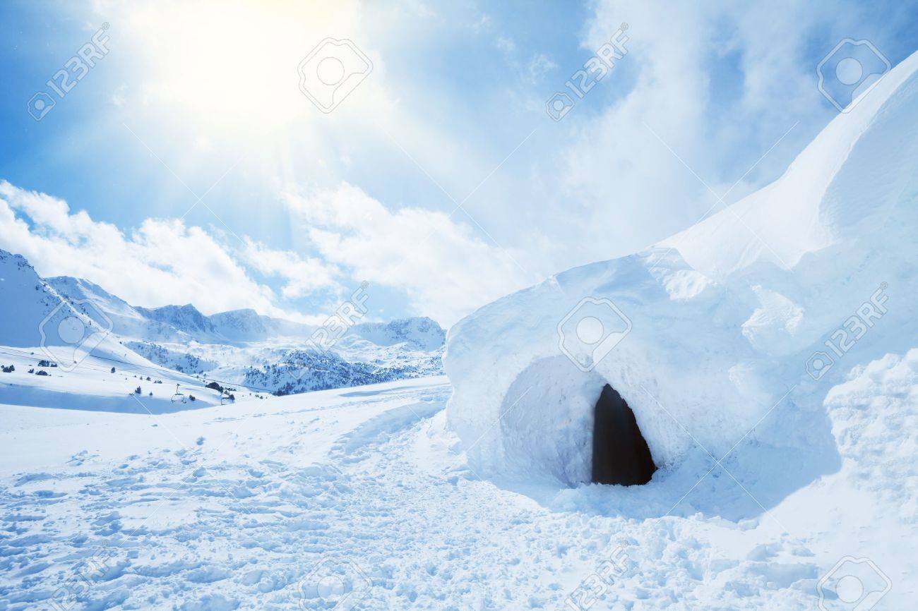 Igloo And Snow Shelter In High Snowdrift With Mountains Peaks