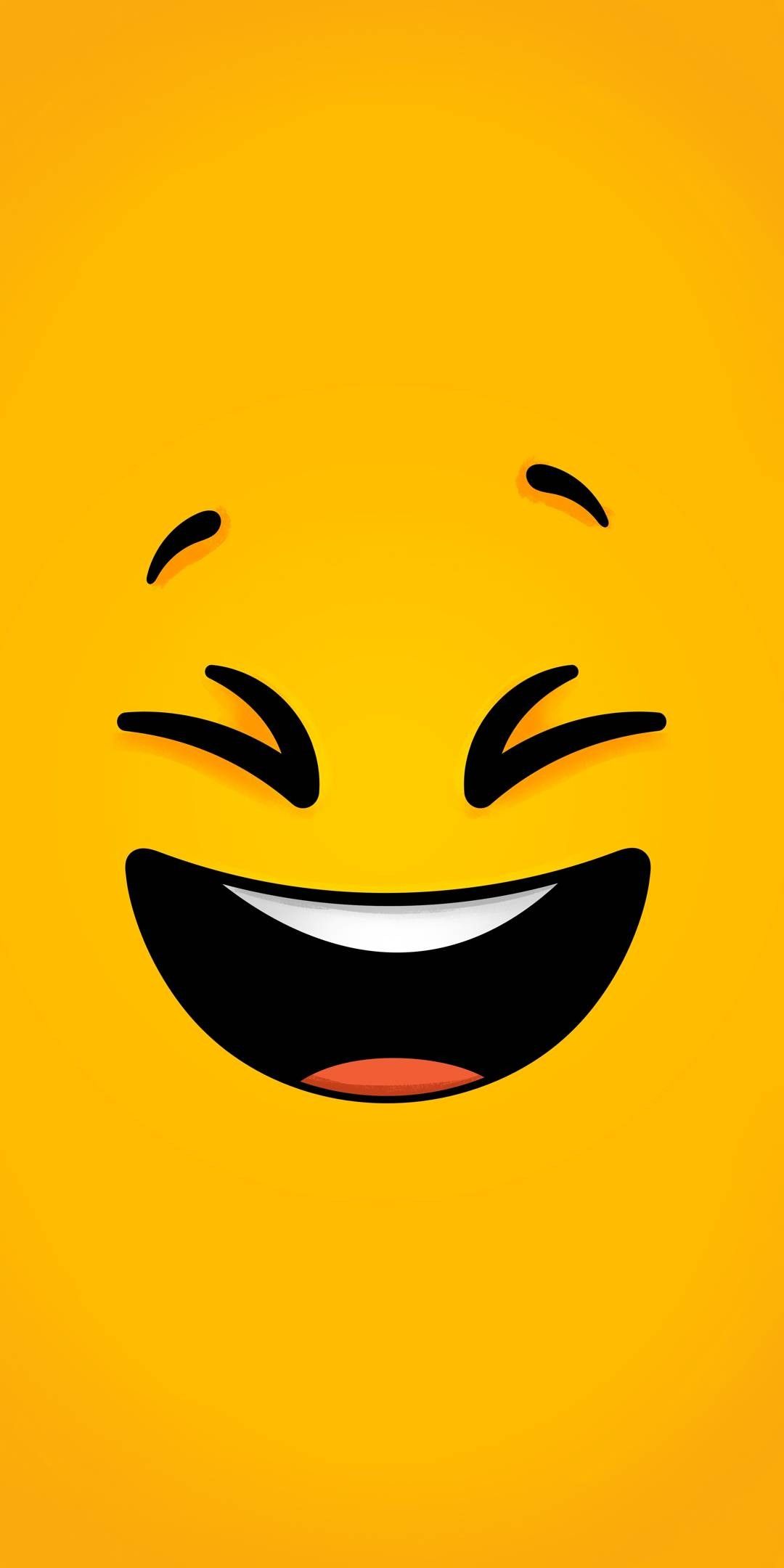 Close-up of a laughing emoji on a bright yellow background