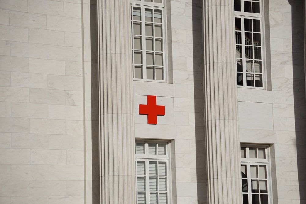 Red Cross On White Concrete Building Photo Image