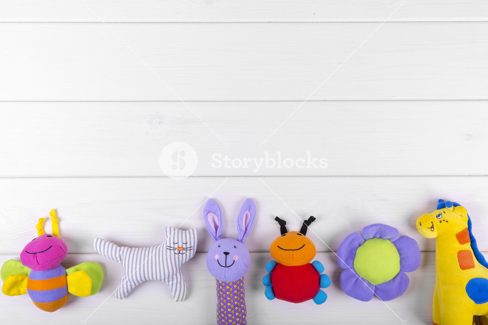 stuffed baby toys on wooden background with copy space Royalty