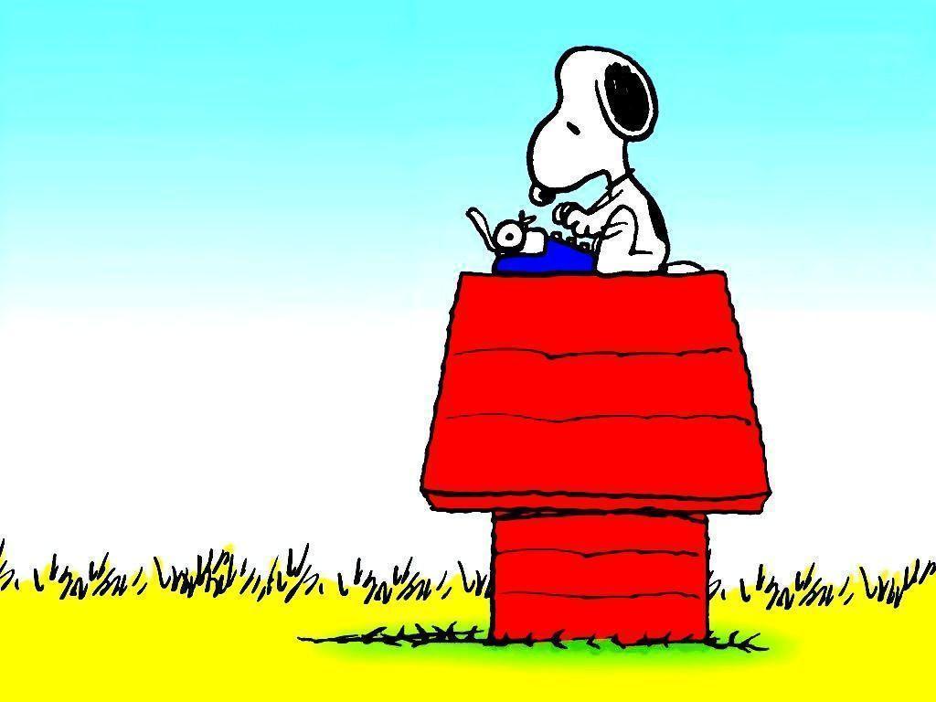 Snoopy typing on a typewriter on top of his red doghouse
