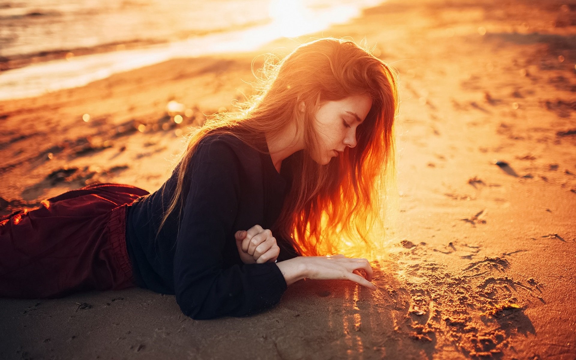 Long hair girl lying on beach sunshine dusk wallpaper
