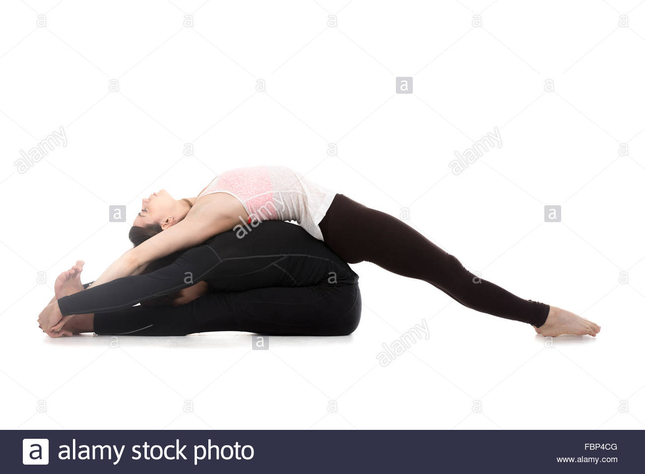 Sporty Young Couple On White Background Doing Acroyoga Fitness Or