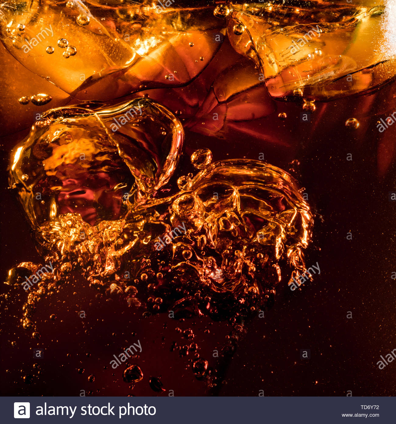 free-download-close-up-view-of-the-ice-cubes-in-dark-cola-background