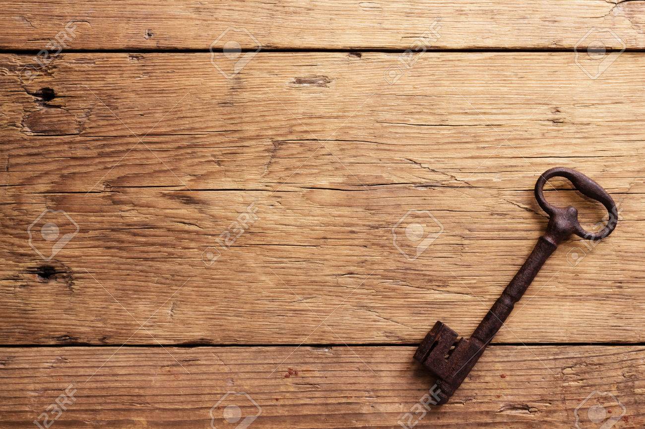 Old Key On A Wooden Background Stock Photo Picture And Royalty