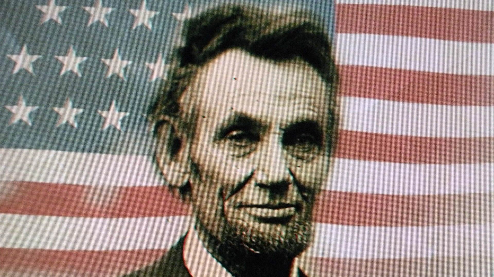 Portrait of Abraham Lincoln, the 16th President of the United States, against the backdrop of the American flag. This image symbolizes Lincoln's leadership during the Civil War and his role as the first Republican president