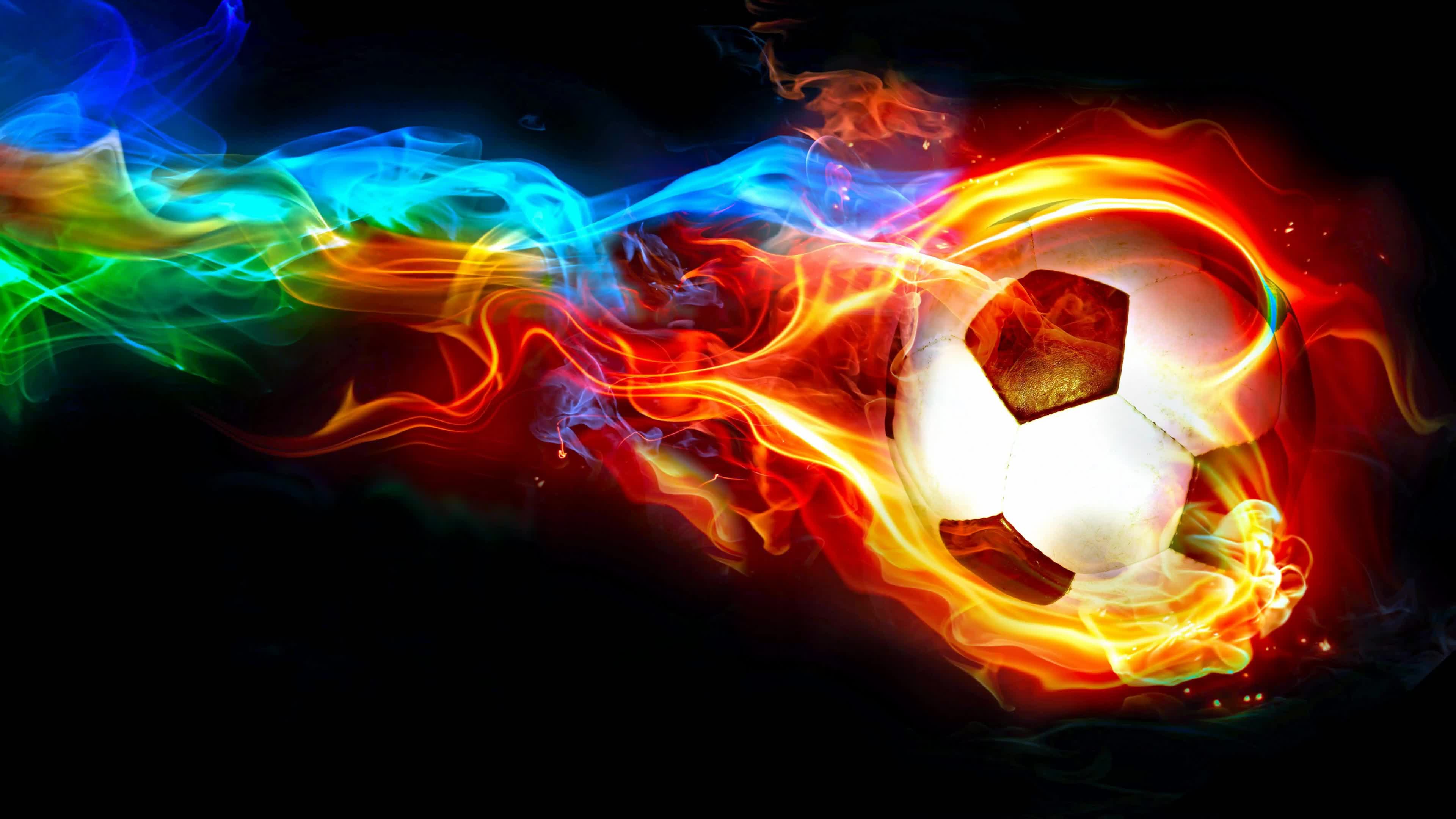 A soccer ball engulfed in vibrant flames of red, orange, and blue, set against a black background. This dynamic and energetic image evokes a sense of passion and excitement for the sport
