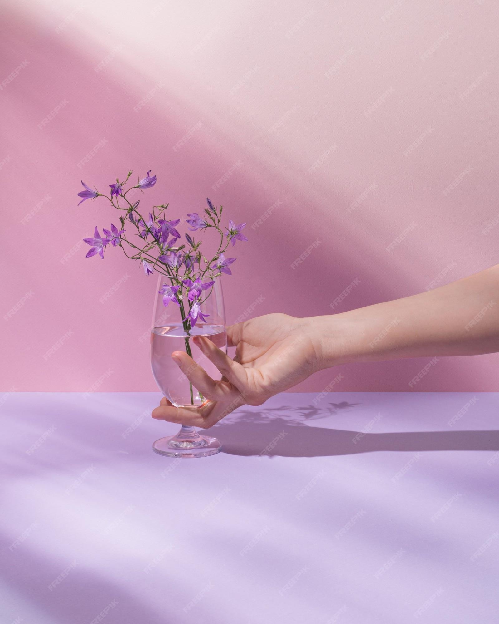 Premium Photo Hand Holding Glass With Transparent Liquid And