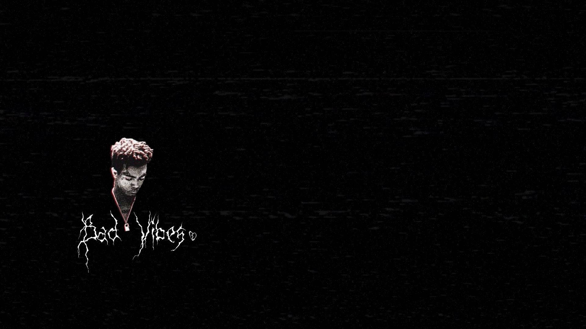 Dark aesthetic wallpaper featuring XXXTentacion with 'Bad Vibes' text overlay