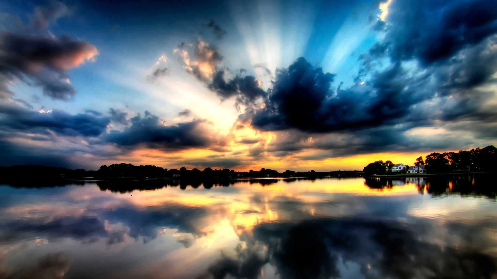 A breathtaking sunset over a tranquil lake, with dramatic clouds and vibrant colors reflected in the water