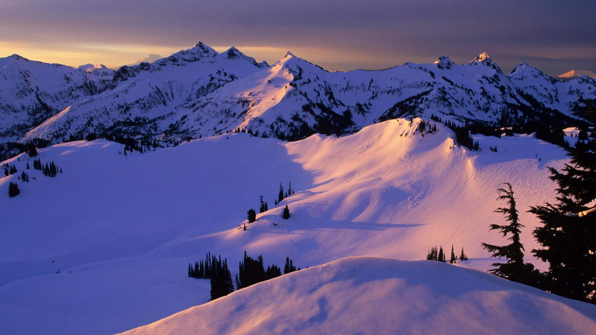 Sunset over snow-covered mountains, winter landscape