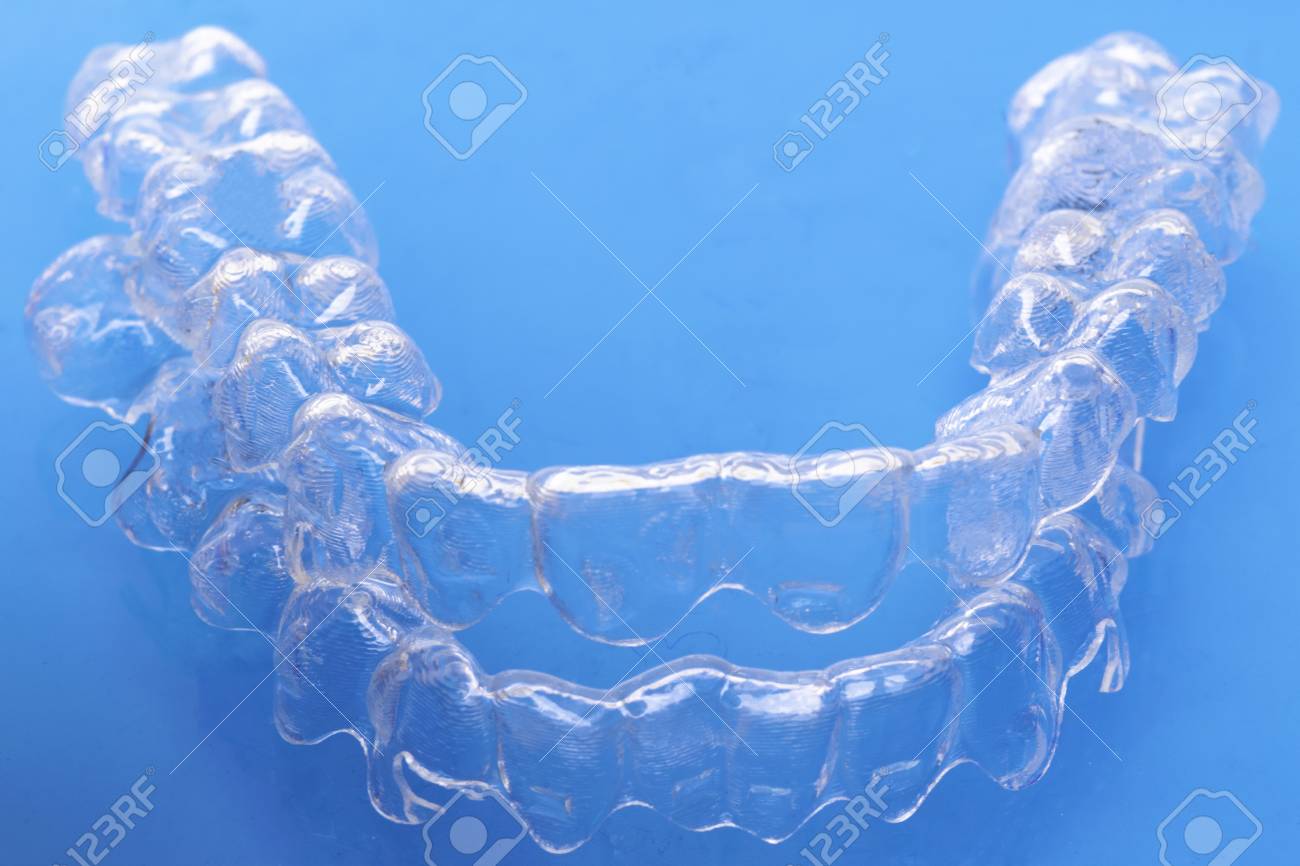 Invisible Dental Teeth Brackets Tooth Aligners On Blue Background