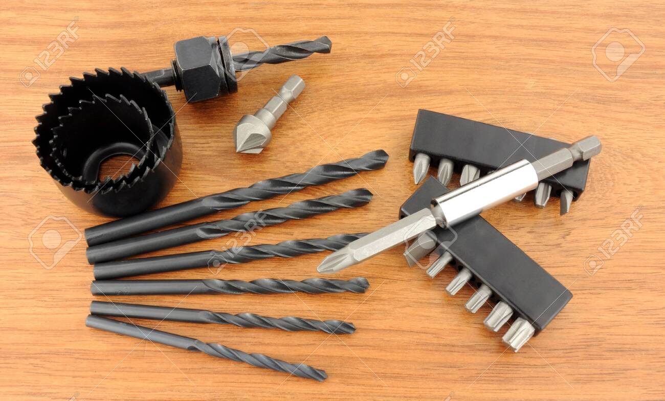 Hole Saw And Drill Bit Set On A Wooden Background Stock Photo