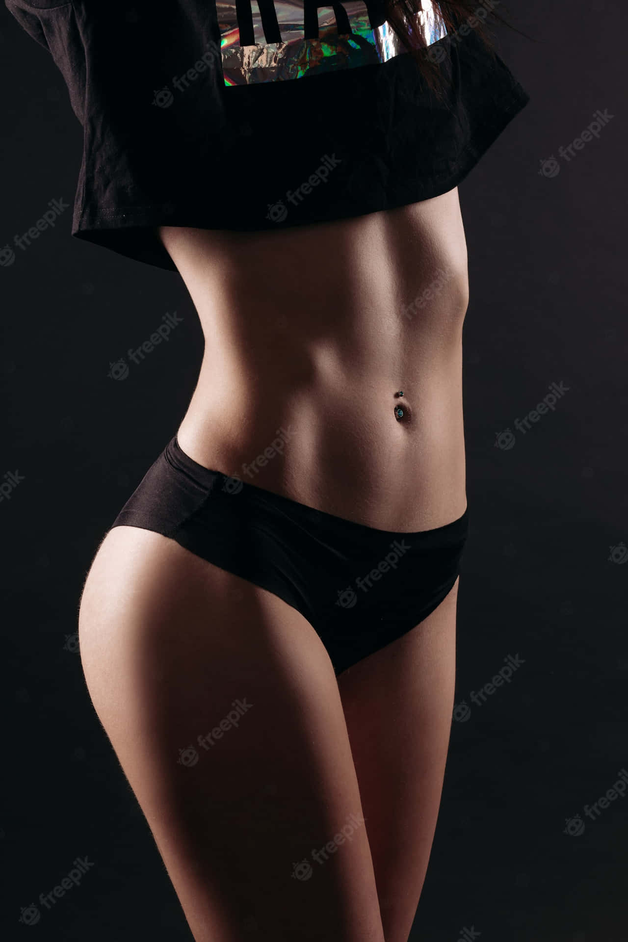 Fit Woman Showcasing Her Perfectly Toned Physique Against A Wallpaper