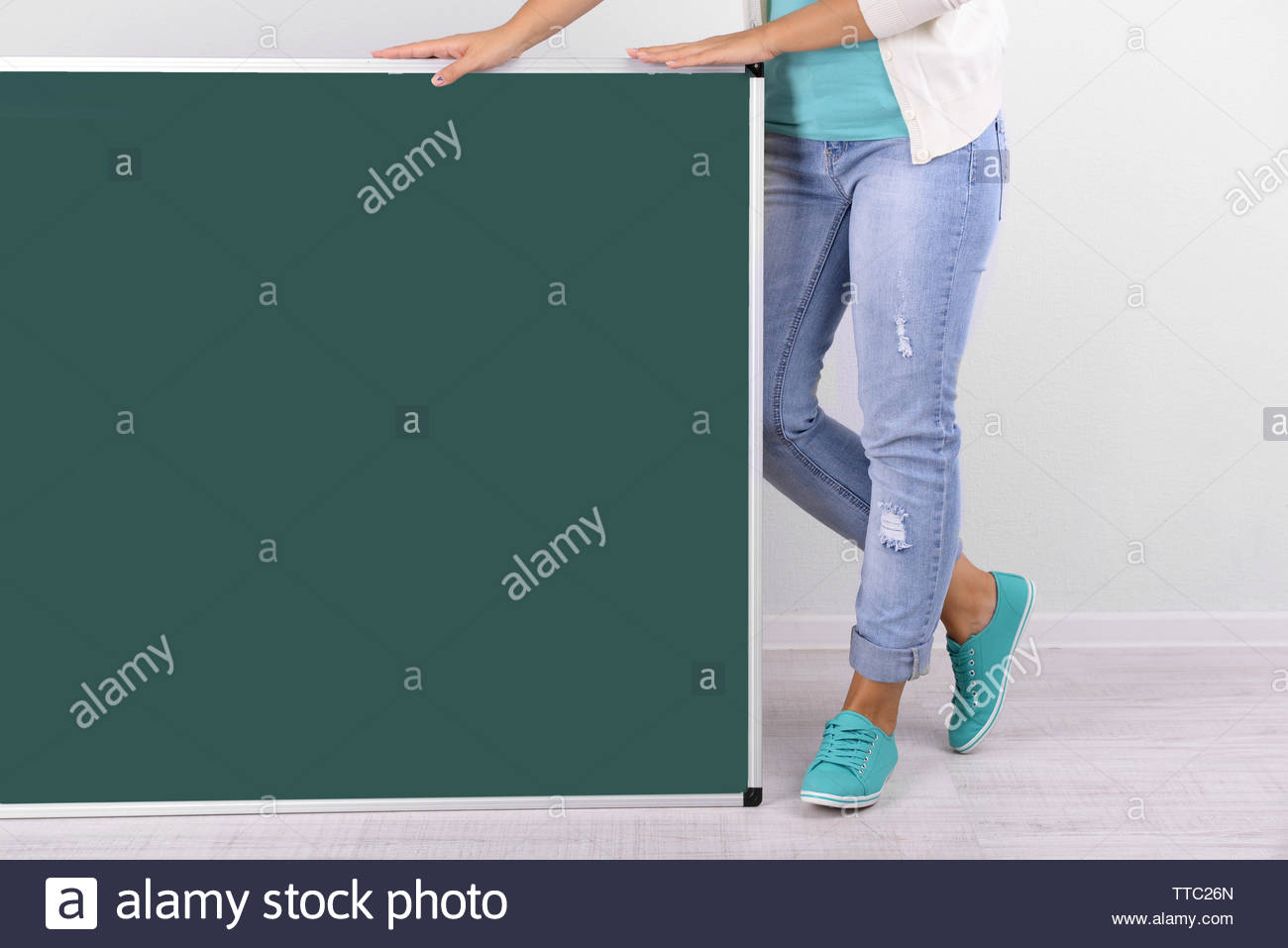 Woman In Causal With Green Blackboard On Grey Background Close Up