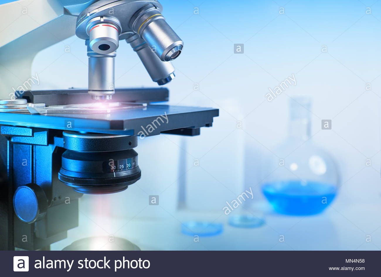 Scientific Background With Closeup On Light Microscope And