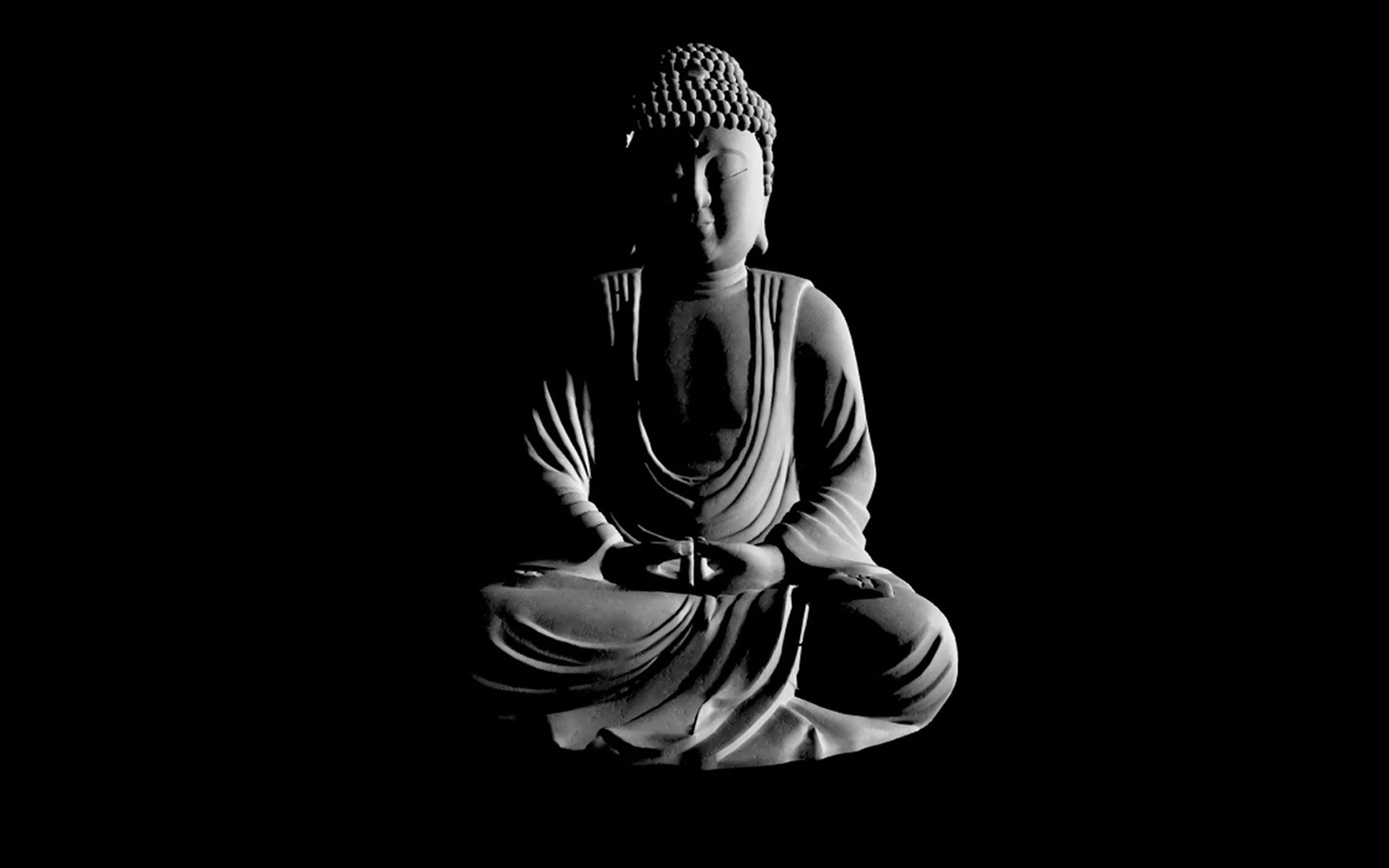 Black and white image of a serene Buddha statue in meditation against a dark background