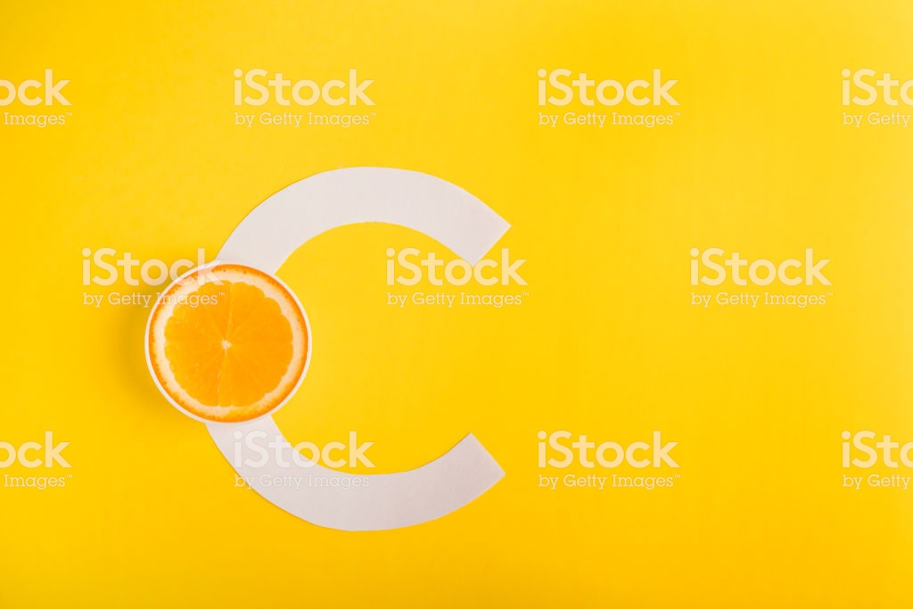 Orange And Letter C On A Yellow Background The Concept Of Vitamin