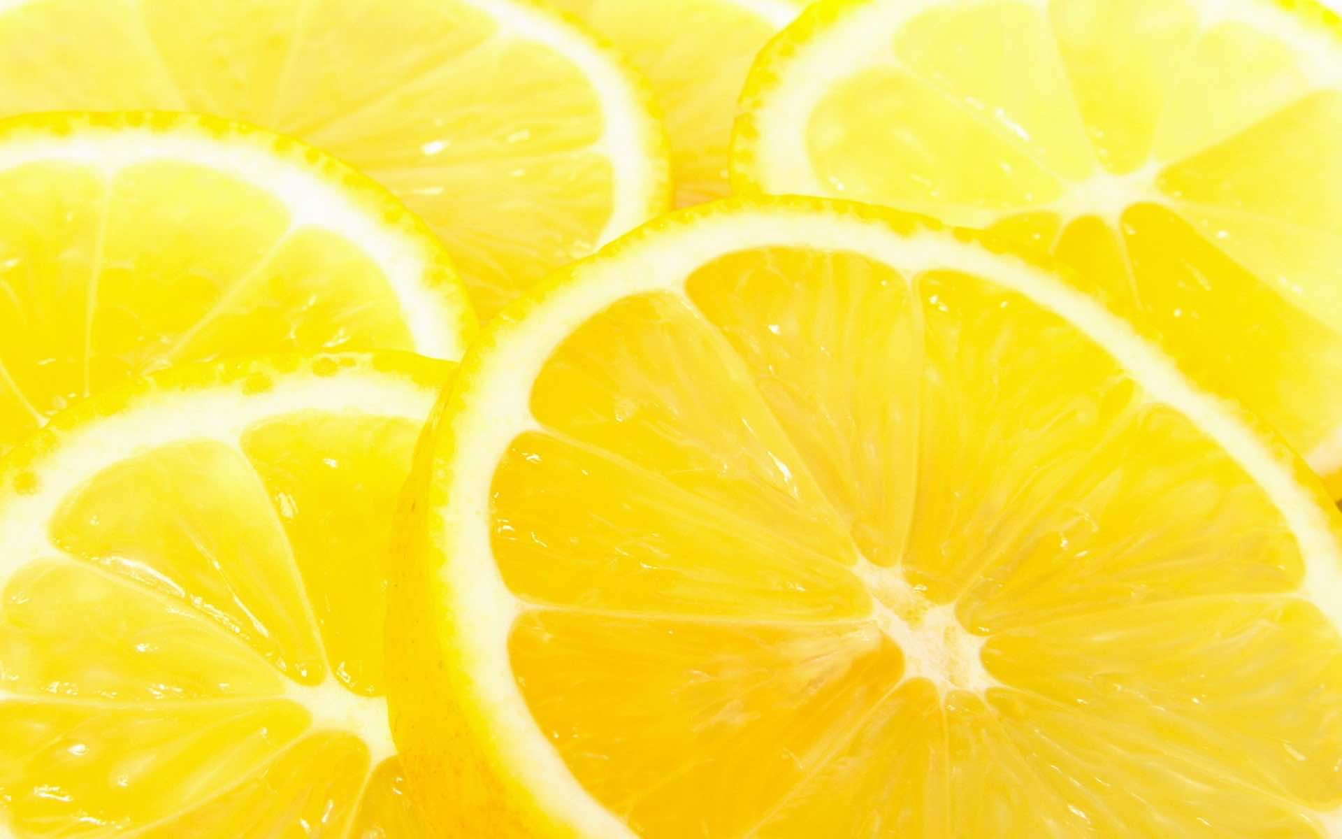 Close-up of vibrant yellow lemon slices, showcasing their juicy texture and radiating a sunny, citrusy freshness