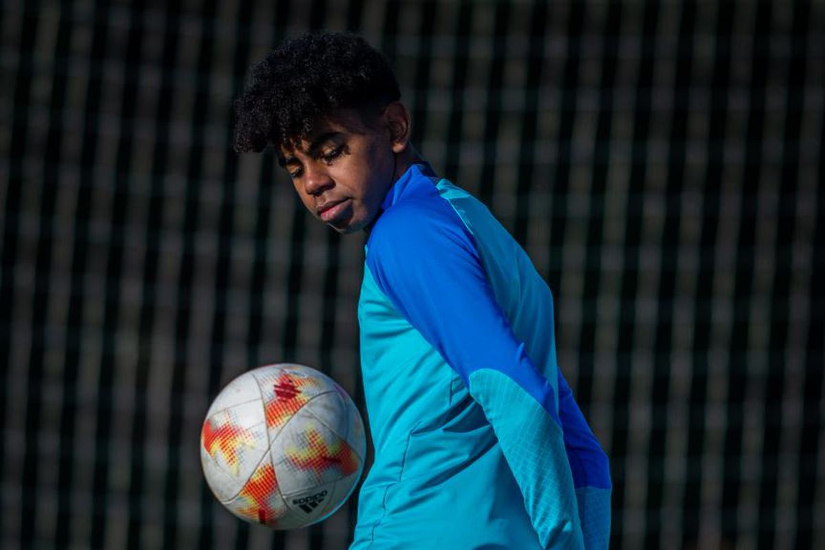 Lamine Yamal in action, skillfully controlling a soccer ball. The young footballer displays focus and concentration during practice