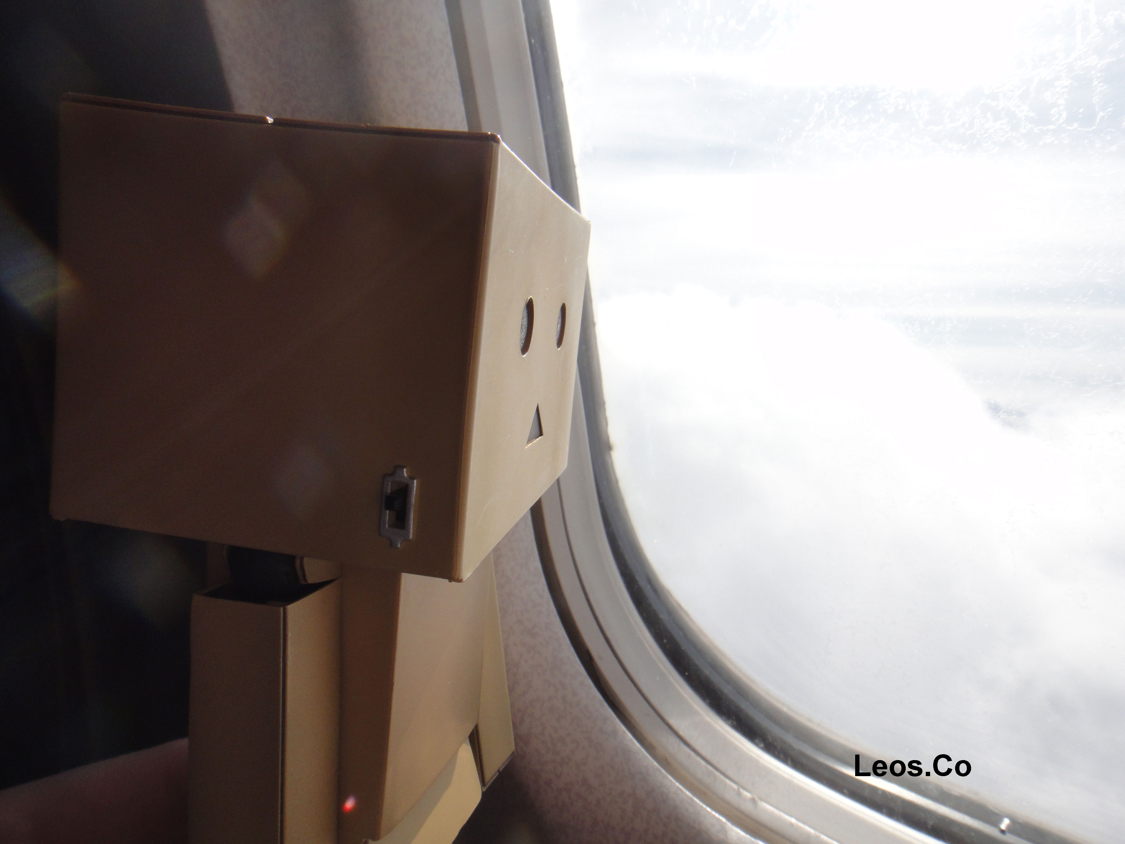 Danbo Looking Out Of A Plane S Window Wallpaper