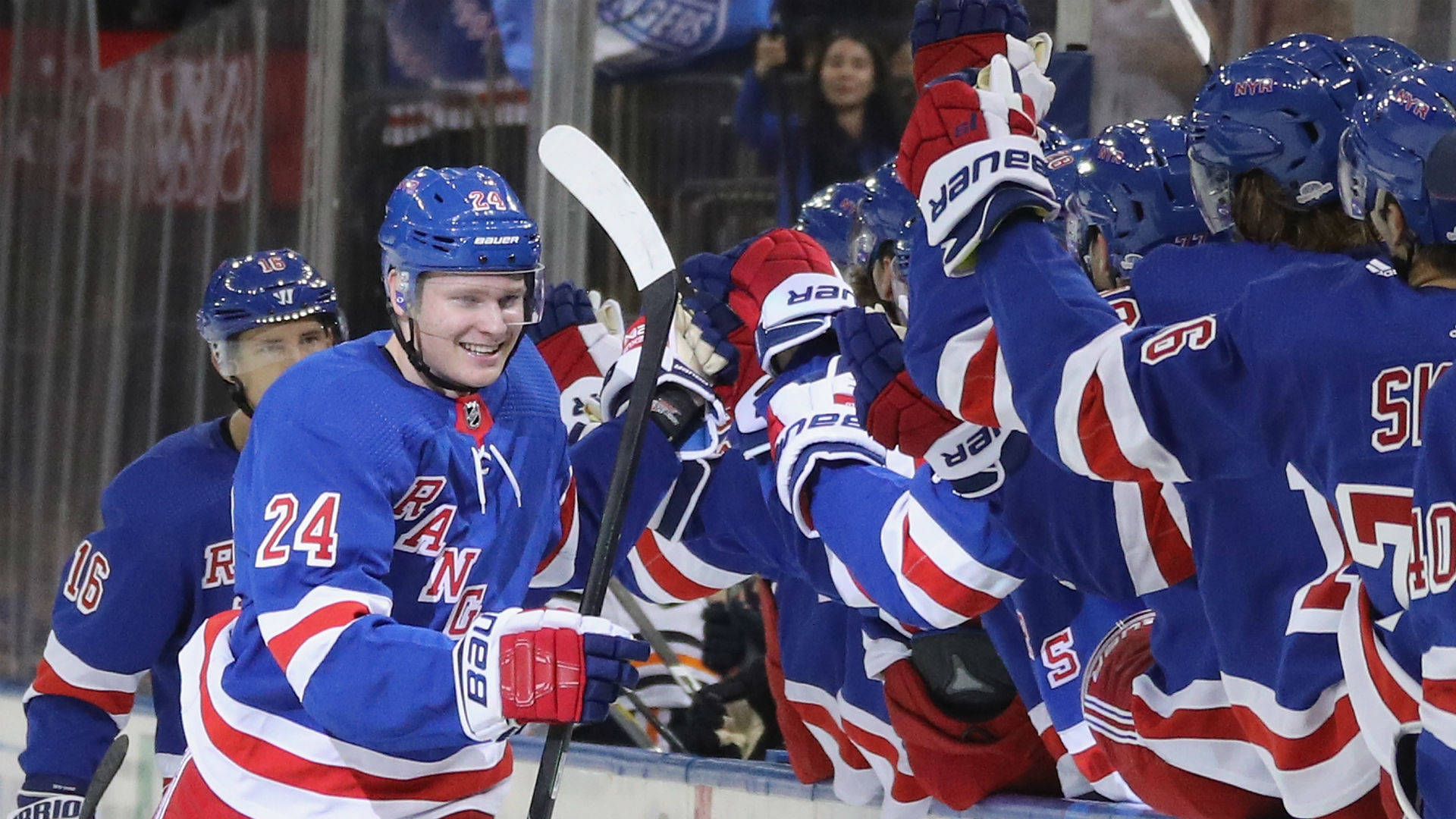 New York Rangers players celebrating a goal on the ice