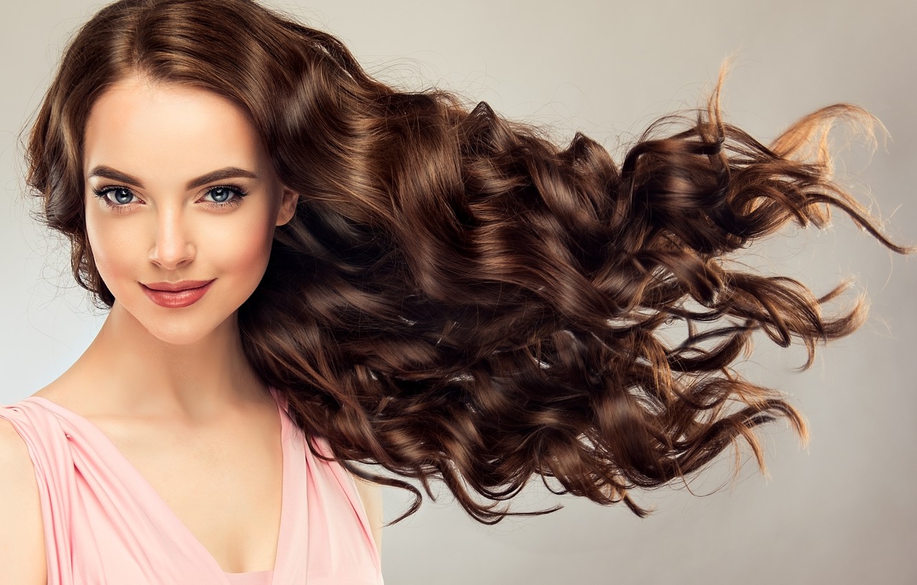 Curly Hair Model. Woman Wavy Long Hairstyle. Brunette Fashion Girl with  Volume Hairdo and Natural Make Up Over Beige Background Stock Image - Image  of background, attractive: 242865635