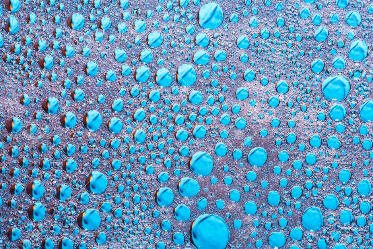 Water Drops On Glass With The Foam Of Dishwasher Blue