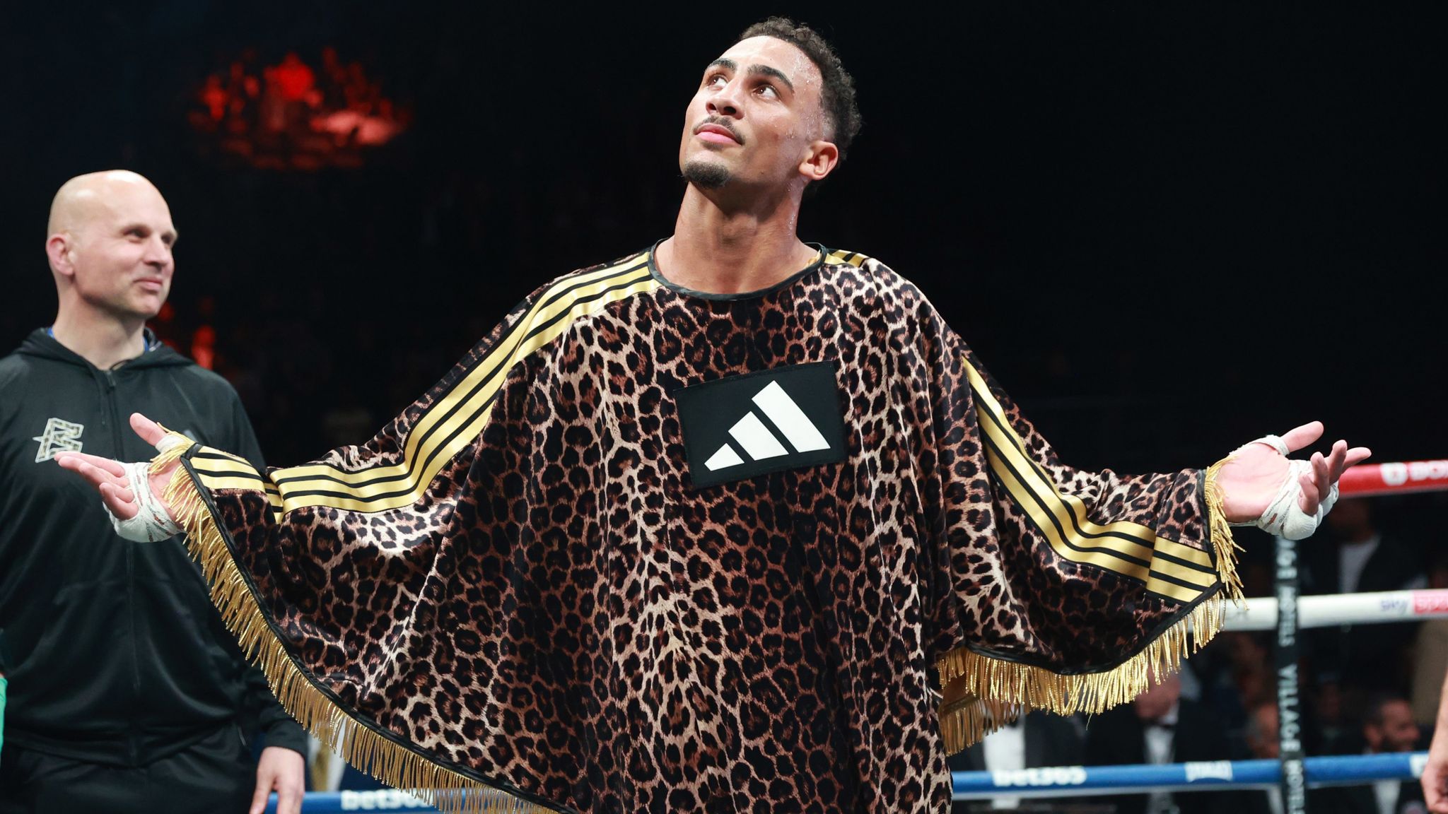 Benjamin Whittaker wearing a leopard-print poncho with the Adidas logo in a boxing ring