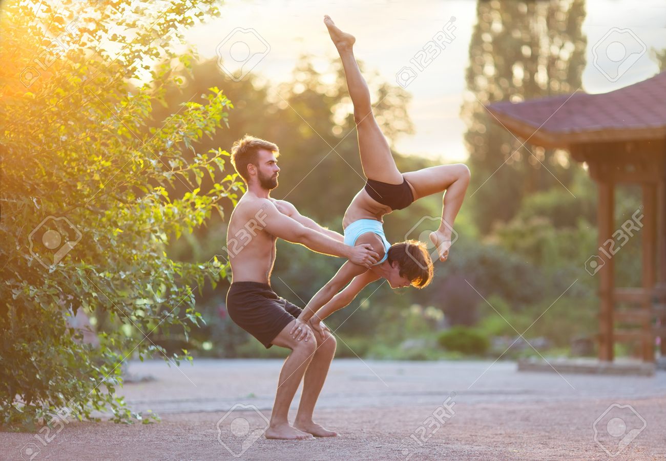 Acro Yoga Two Sporty People Practice In Pair Couple Doing