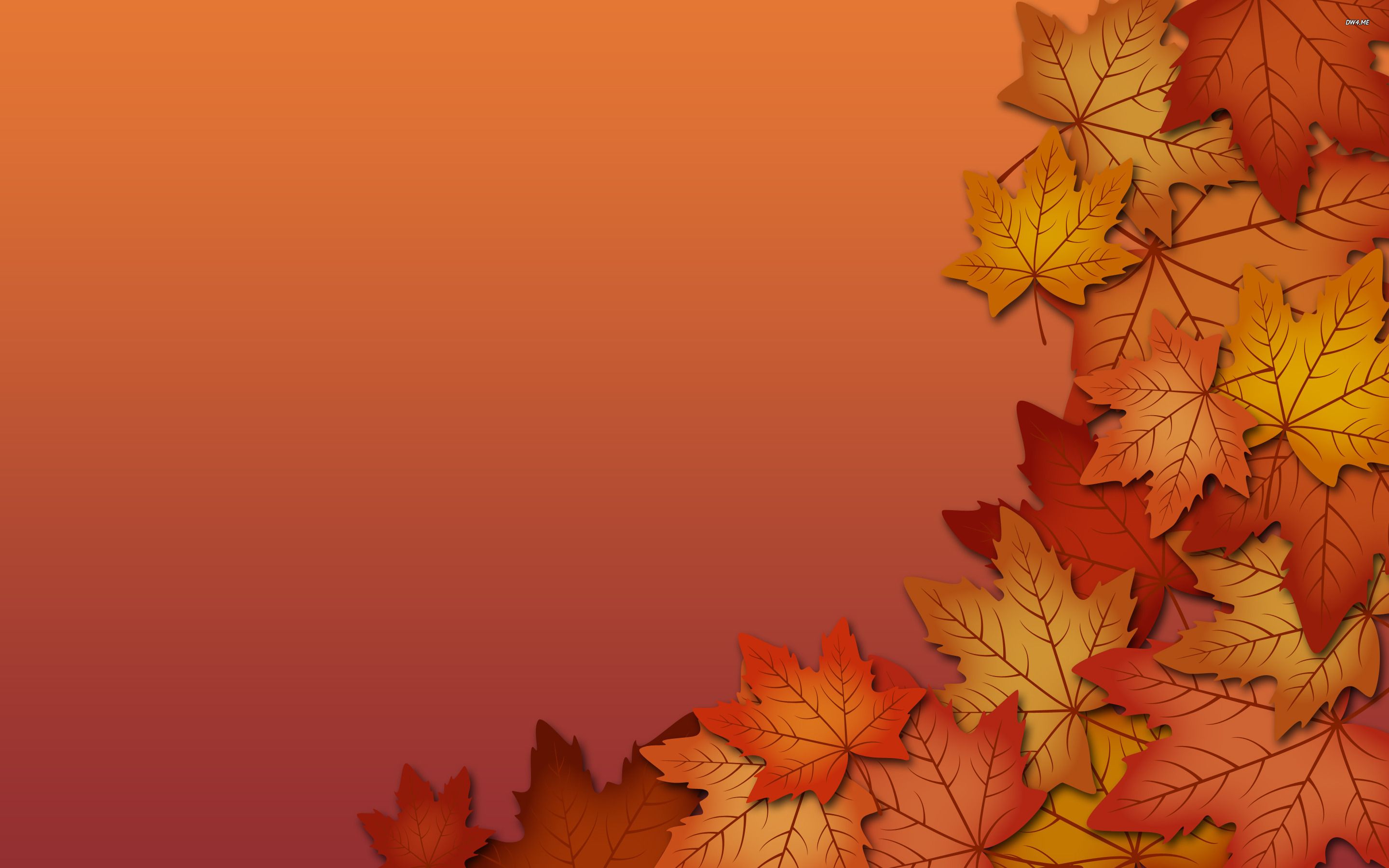 Vibrant fall leaves arranged on a warm autumnal background