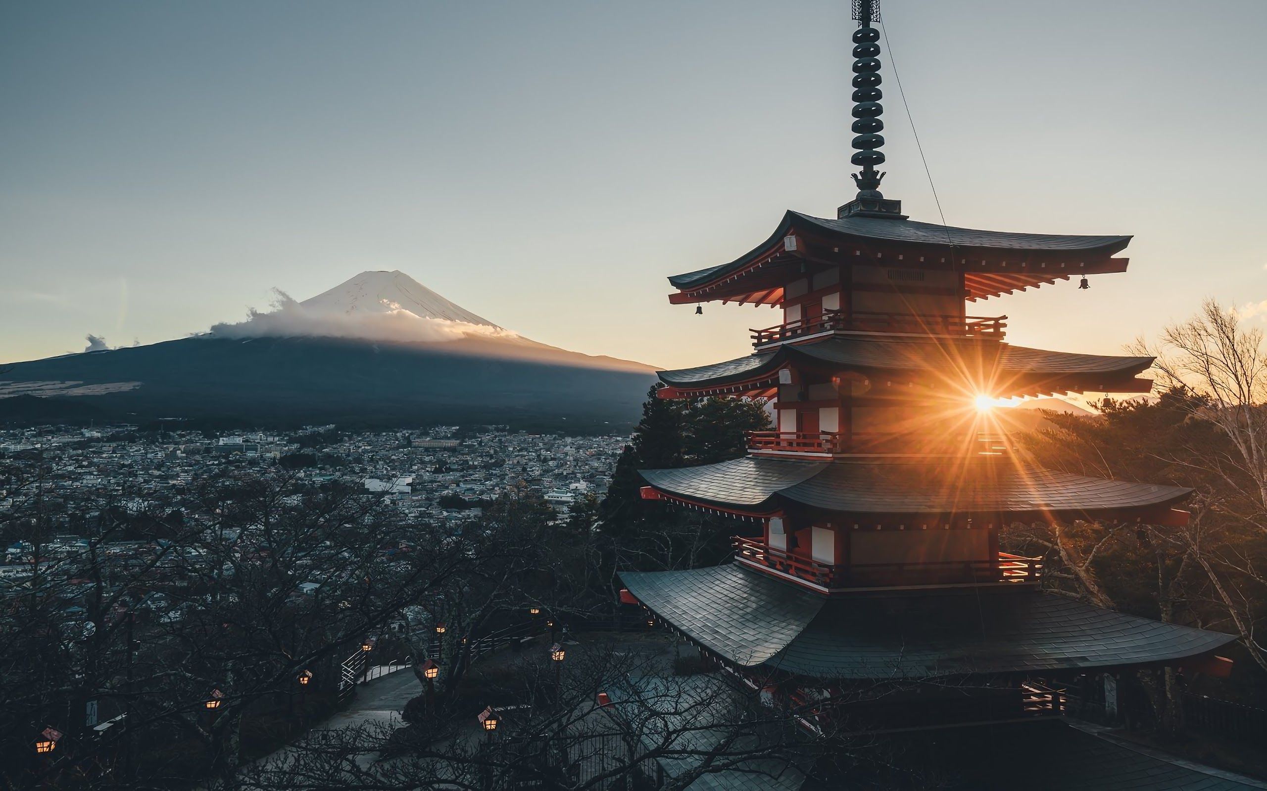 A stunning 4k wallpaper of a traditional Japanese pagoda with Mount Fuji in the background during sunset
