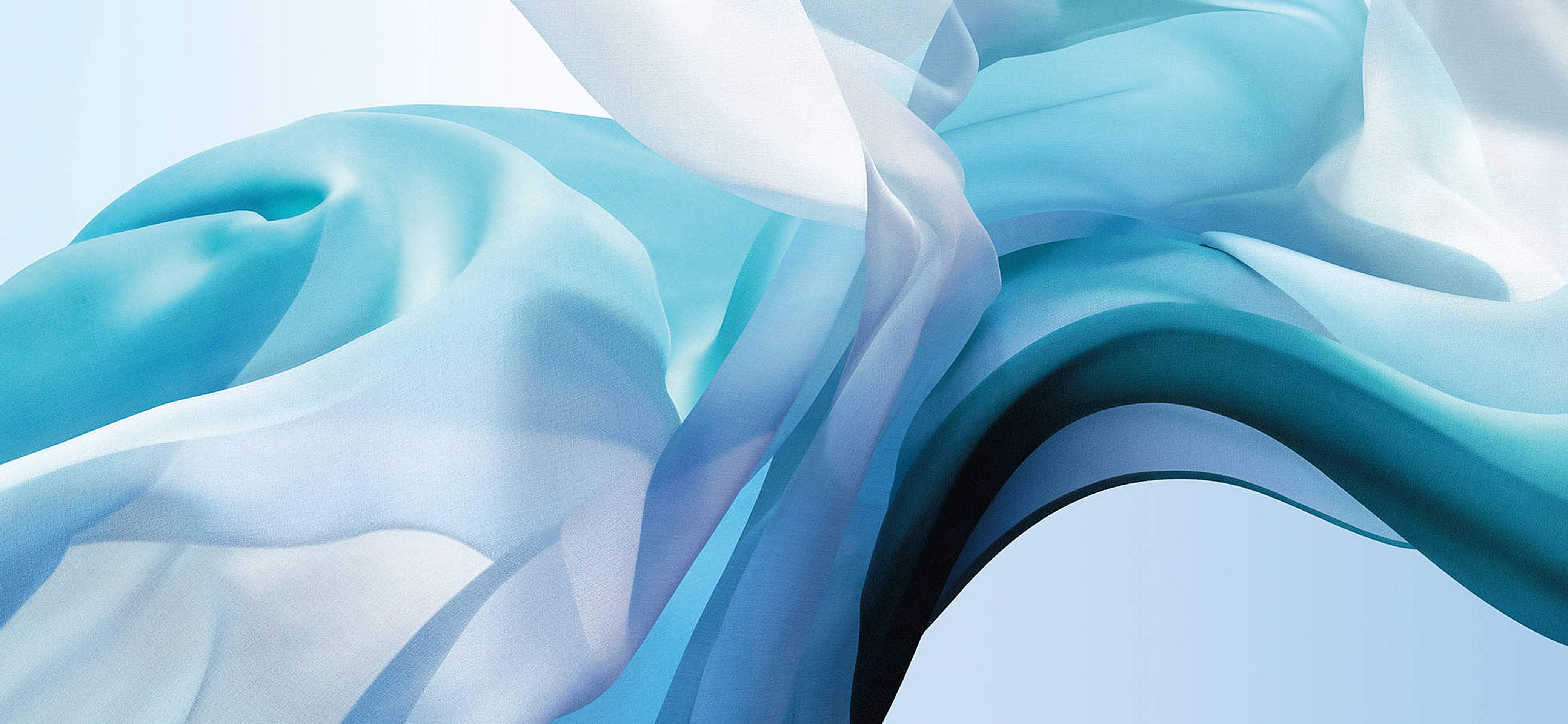 Abstract wallpaper with flowing blue and teal fabric, reminiscent of the official MacBook Air wallpaper