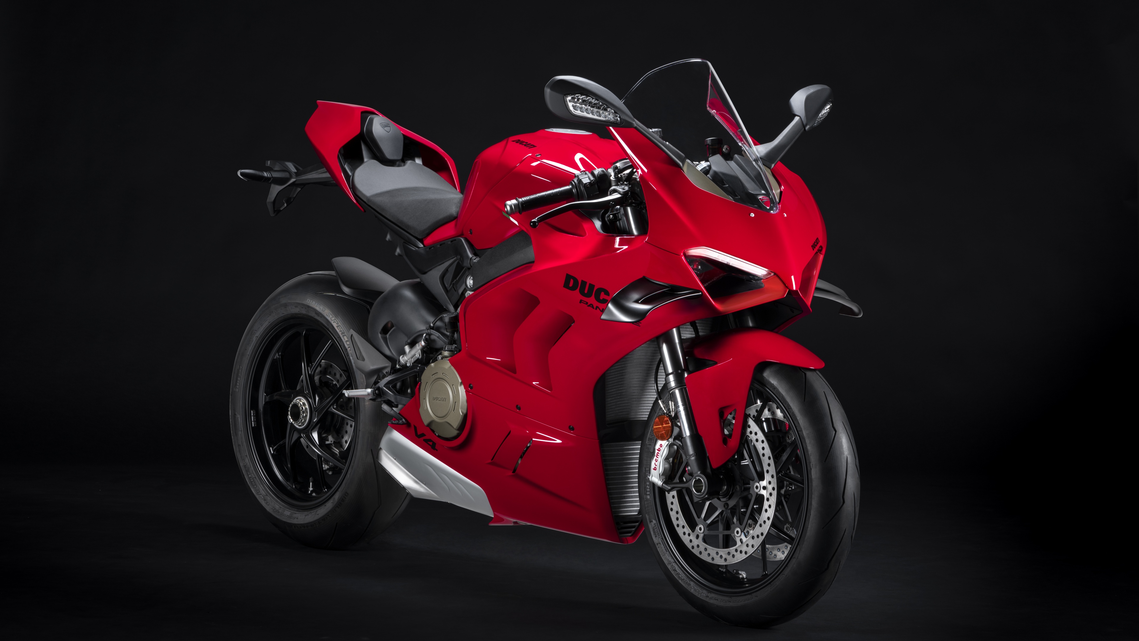 Red Ducati Panigale V4 S sports motorcycle against a black background