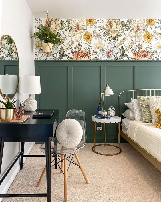 An Eye Catchy Bedroom With Bold Floral Wallpaper Green Paneling A Metal Bed Neutral Bedding Nightstand Black Vanity And Clear Chair