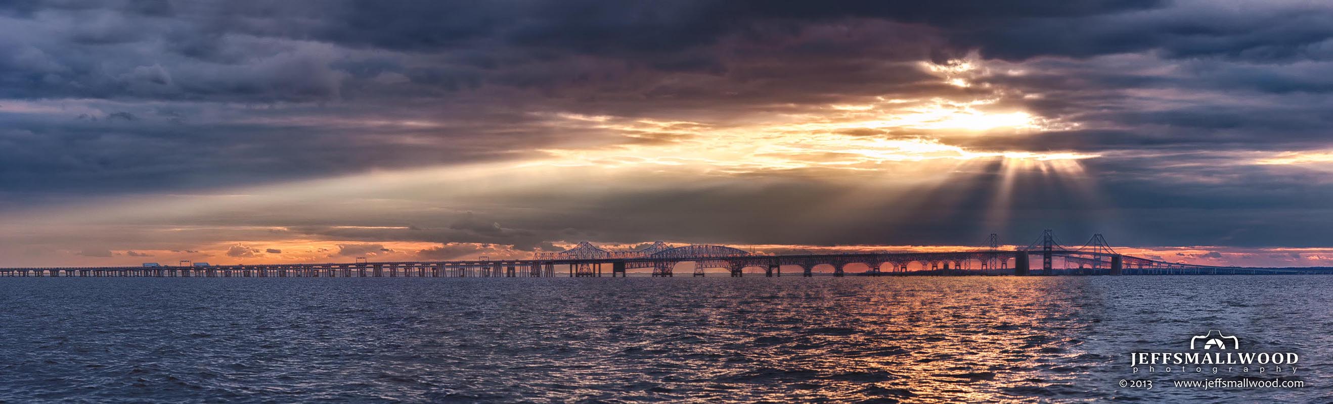 Through A Hole In The Clouds Over Chesapeake Bay Bridge At Sunset