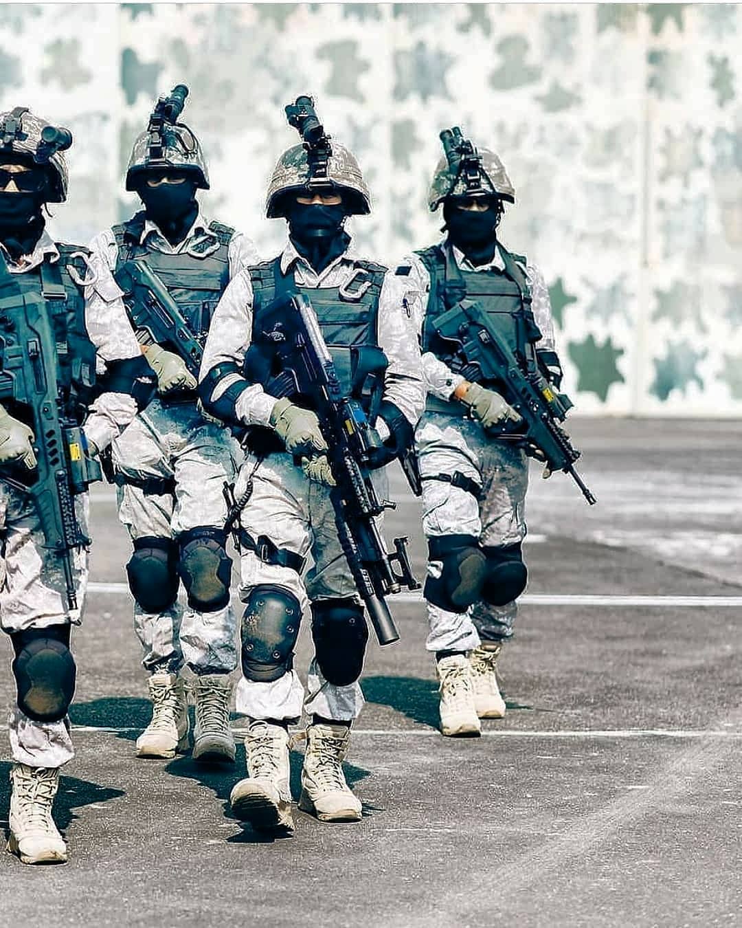 Elite marine commandos in advanced tactical gear demonstrating disciplined formation during an exercise