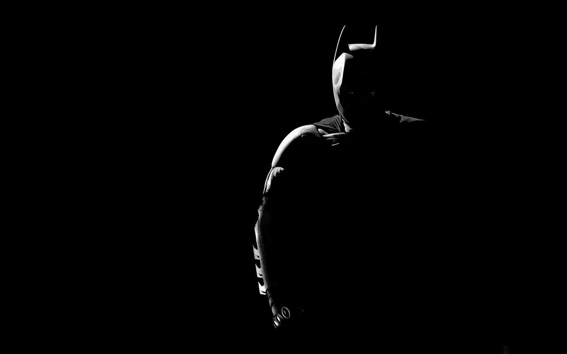 Batman In The Dark Silhouetted Against A Black Background