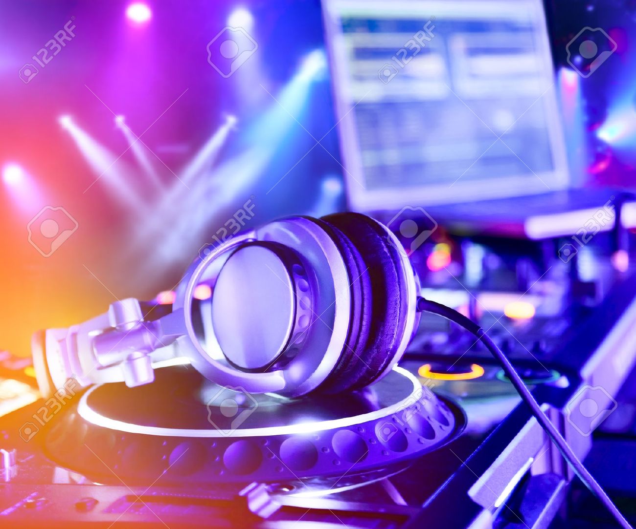 Dj Mixer With Headphones At Nightclub In The Background Laser