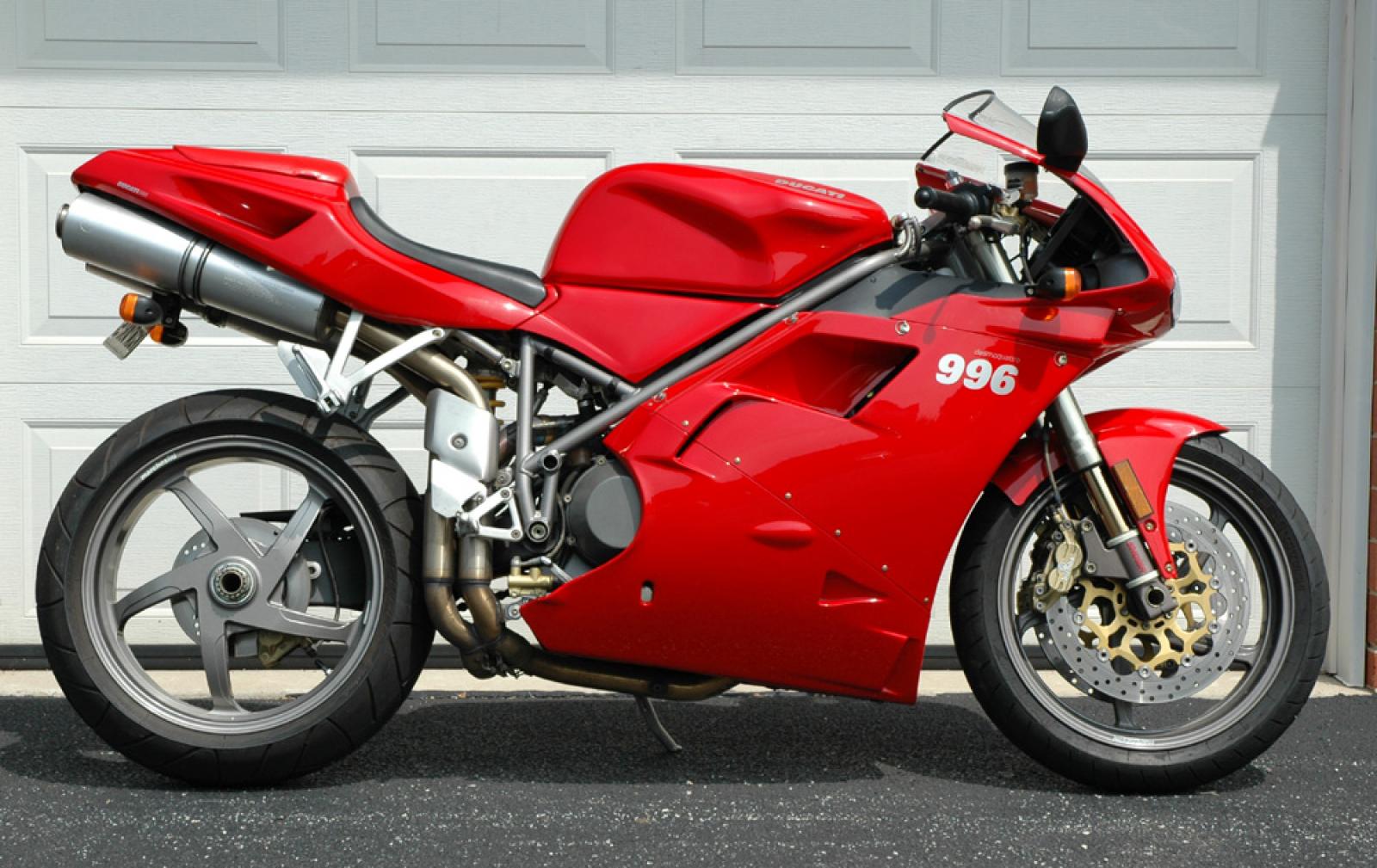 Red Ducati 996 Motorcycle Parked in Front of Garage Door